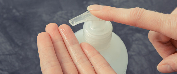 Hands with disinfectant liquid or soap for disinfection hands. Stop spreading virus and bacteria