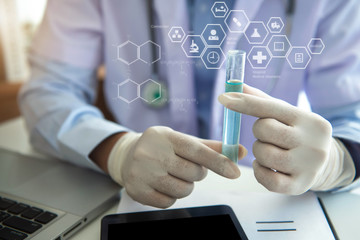 Scientist or tech holds liquid biological sample in gloved hands in the laboratory.