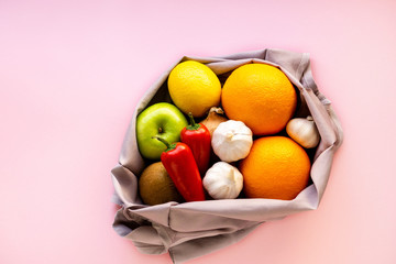 Various fruits and vegetables in reusable fabric bag
