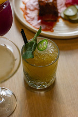 Citrus cocktail with jalapeno and herbs