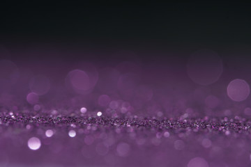 purple Sparkling Lights Festive background with texture. Abstract Christmas twinkled bright bokeh defocused and Falling stars. Winter Card or invitation.