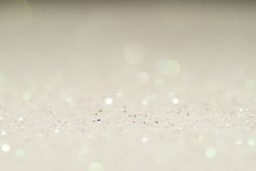 silver Sparkling Lights Festive background with texture. Abstract Christmas twinkled bright bokeh defocused and Falling stars. Winter Card or invitation.