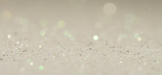 silver Sparkling Lights Festive background with texture. Abstract Christmas twinkled bright bokeh defocused and Falling stars. Winter Card or invitation.