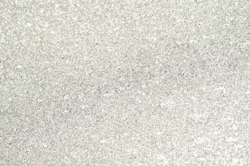 silver Sparkling Lights Festive background with texture. Abstract Christmas twinkled bright bokeh defocused and Falling stars. Winter Card or invitation.