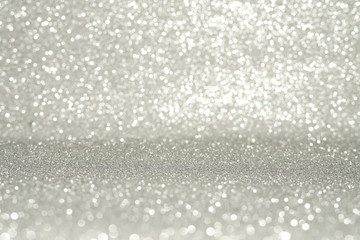 silver Sparkling Lights Festive background with texture. Abstract Christmas twinkled bright bokeh defocused and Falling stars. Winter Card or invitation.