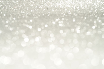silver Sparkling Lights Festive background with texture. Abstract Christmas twinkled bright bokeh defocused and Falling stars. Winter Card or invitation.