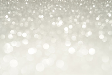 silver Sparkling Lights Festive background with texture. Abstract Christmas twinkled bright bokeh...