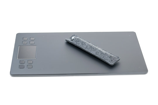 Graphic tablet with a pencil in a case isolated on a white background.