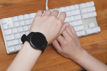 hands on keyboard Looking at the watch