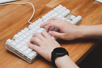 hands typing on keyboard