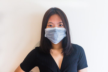 Asian young girl is wearing medical face masks to protect from Coronavirus