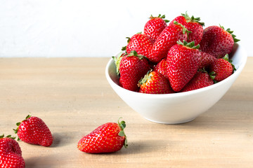 White bowl of fresh  strawberries
