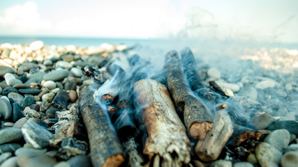 coals and firewood by the sea
