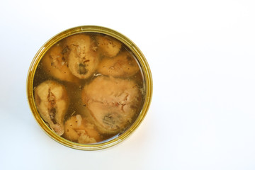 Open can of preserved fish on white background. Top view, copy space