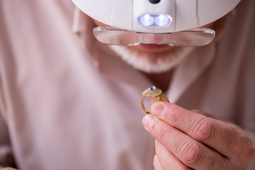 Old male jeweler at workshop