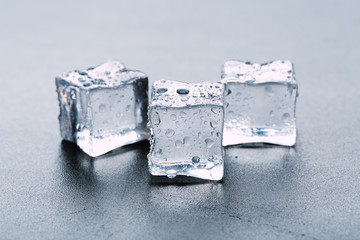Pyramid of beautiful thawed ice cubes with drops of water