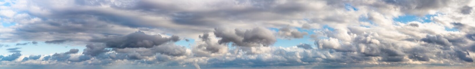 Fantastic clouds against blue sky, panorama