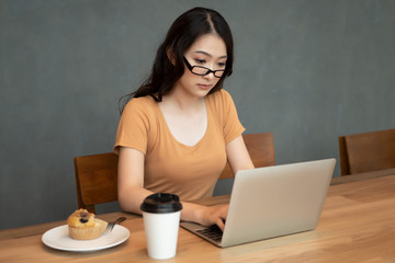 serious asian business woman; woman office worker working at home with laptop computer; concept of business in epidemic crisis, social distancing, physical distancing, disease outbreak mitigation
