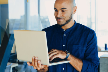 African american businessman sitting at a computer in his startup office