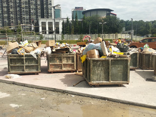 Huge wasted disposal bin used to collect rubbish and unused material from the construction site. Has a fixed collection schedule