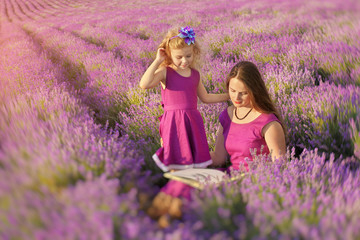 Little girl and mother at meadow of lavender