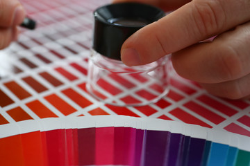 Employee refueling cartridge service holds magnifying glass in hand. Color print of statistics...