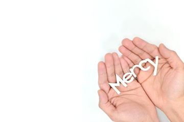 Hands praying for mercy in white background. Covid-19 coronavirus pandemic crisis.