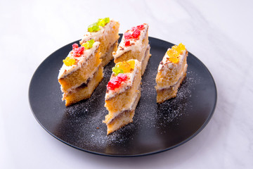 Cake on a black plate close-up