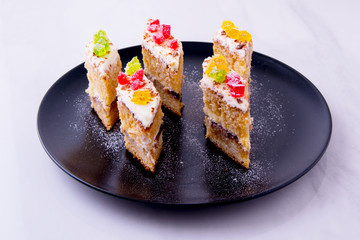 Cake on a black plate close-up