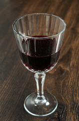 flute of red wine on the wooden background