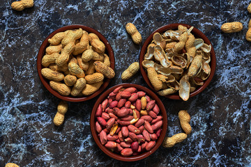 Two bowls with peanuts and one with shells