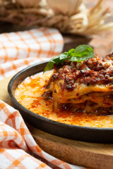 Traditional italian dish. Lasagna made with minced beef bolognese sauce and bechamel sauce topped with basil leaves