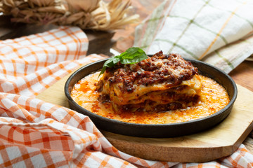 Traditional italian dish. Lasagna made with minced beef bolognese sauce and bechamel sauce topped with basil leaves
