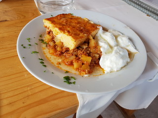 Moussaka - a traditional Balkan specialty with minced meat and potatoes with bulgarian yogurt served in restaurant