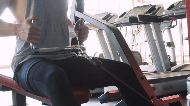 muscular Fit man training on row machine in gym, CrossFit concept. workout, exercises concept