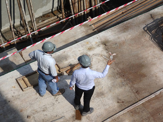 Construction workers having a discussion at the construction site. Important discussions to...