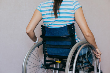Obraz premium Unrecognizable disabled woman in wheelchair at home. Recovery and healthcare concepts.