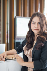 Beautiful Asia business woman over blured office background.