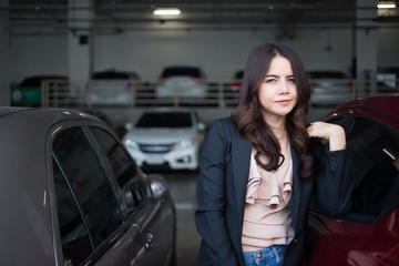 Beautiful Asia business woman over blured parking background.