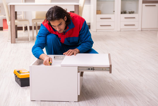 Young male carpenter working indoors