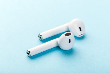  wireless bluetooth headphones lie on a blue background