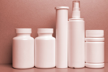 photo of five plastic cans for package pills and vitamins and antiseptic spray for protection...