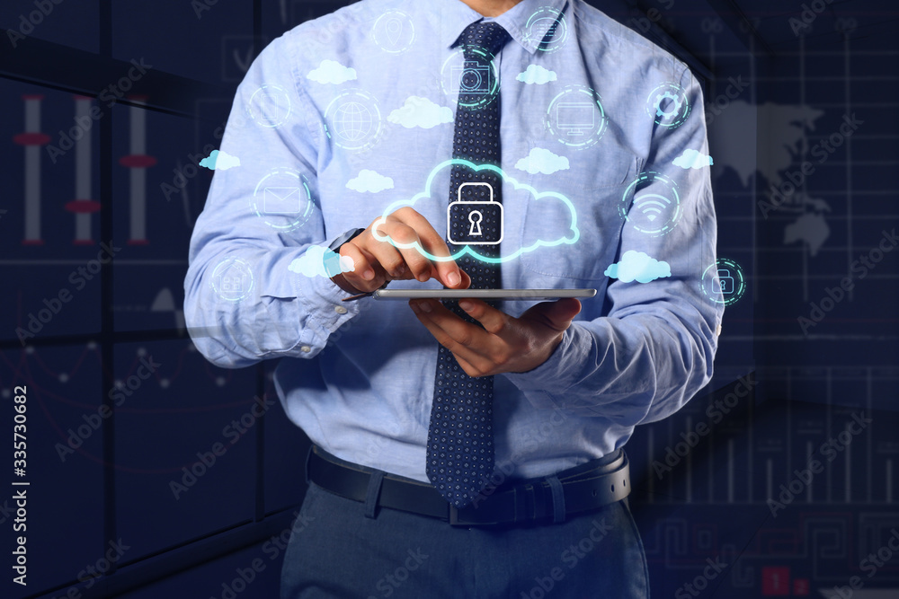 Poster businessman with tablet computer using cloud storage service on dark background