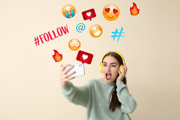 Beautiful female blogger taking selfie on color background