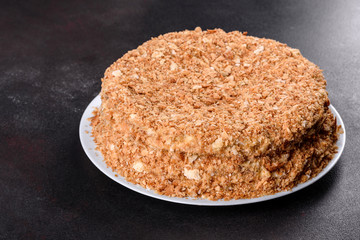 Fresh delicious cake napoleon with cream on a dark background