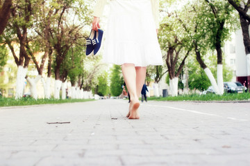 barefoot woman on street alley