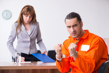Young man meeting with advocate in pre-trial detention