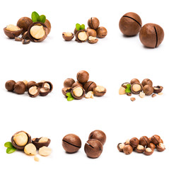 Macadamia nut with pieces and green leaves isolated on a white background