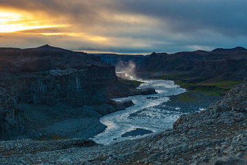 Beautiful waterfalls with mountains in the background at sunset Iceland