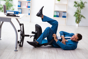Young male employee in work accident concept